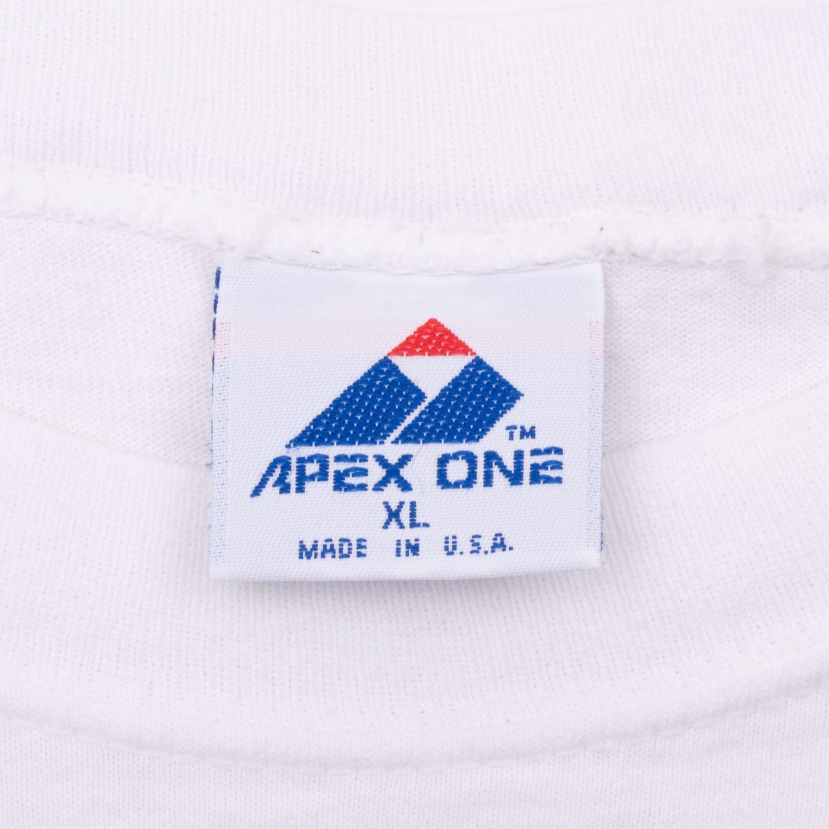 Apex One neck tag marked XL and Made in U.S.A. on white T-shirt