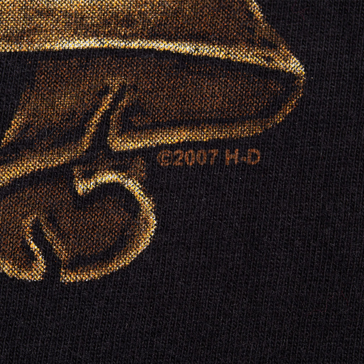 Close-up of small 2007 H-D copyright mark beside the front graphic on black fabric