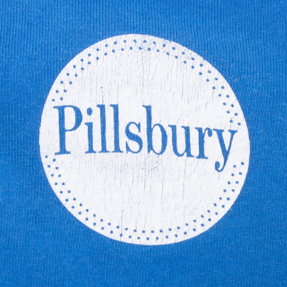 Close-up of circular Pillsbury logo printed on the upper back