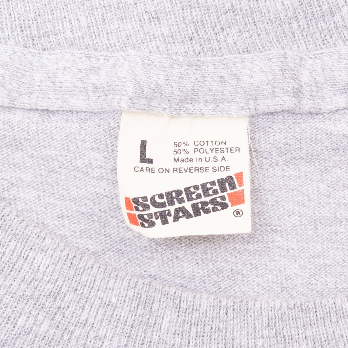 Screen Stars neck label on gray T-shirt showing L, 50% cotton, 50% polyester and Made in USA