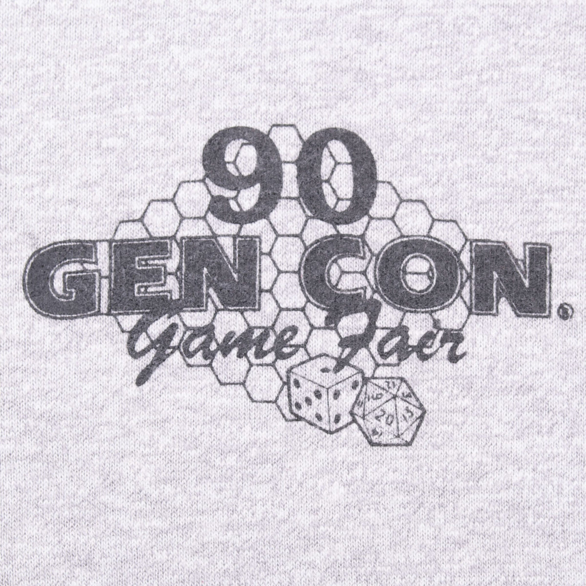 Close-up of black 90 Gen Con Game Fair chest print with dice and hexagon design