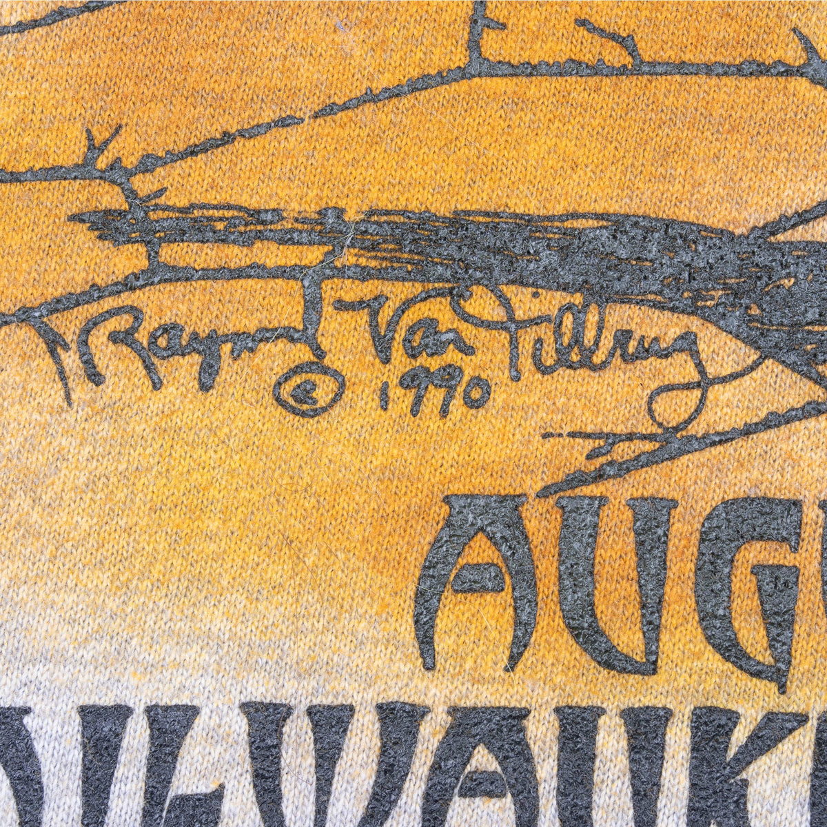 Close-up of artist signature and ’90 date within the orange back graphic