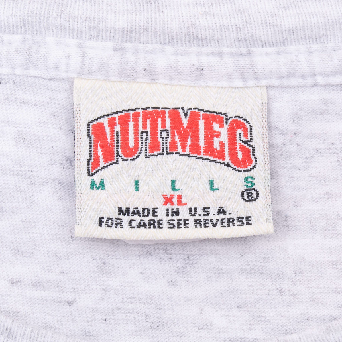 Close-up of Nutmeg Mills neck label with Made in USA care instructions