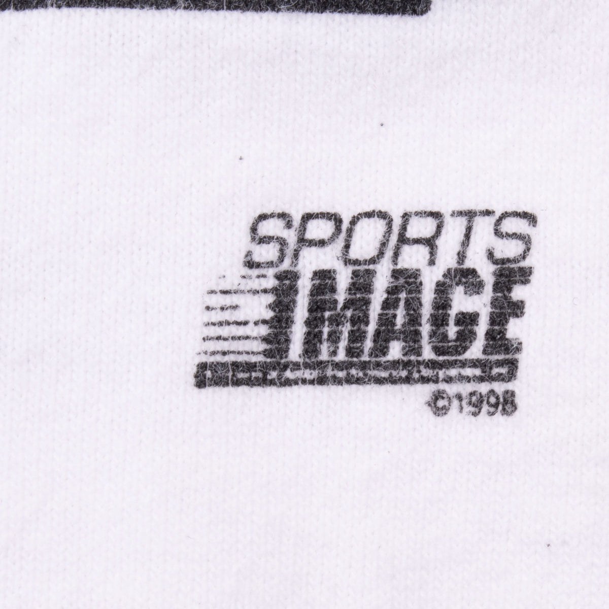 Sports Image 1998 copyright print detail on white fabric