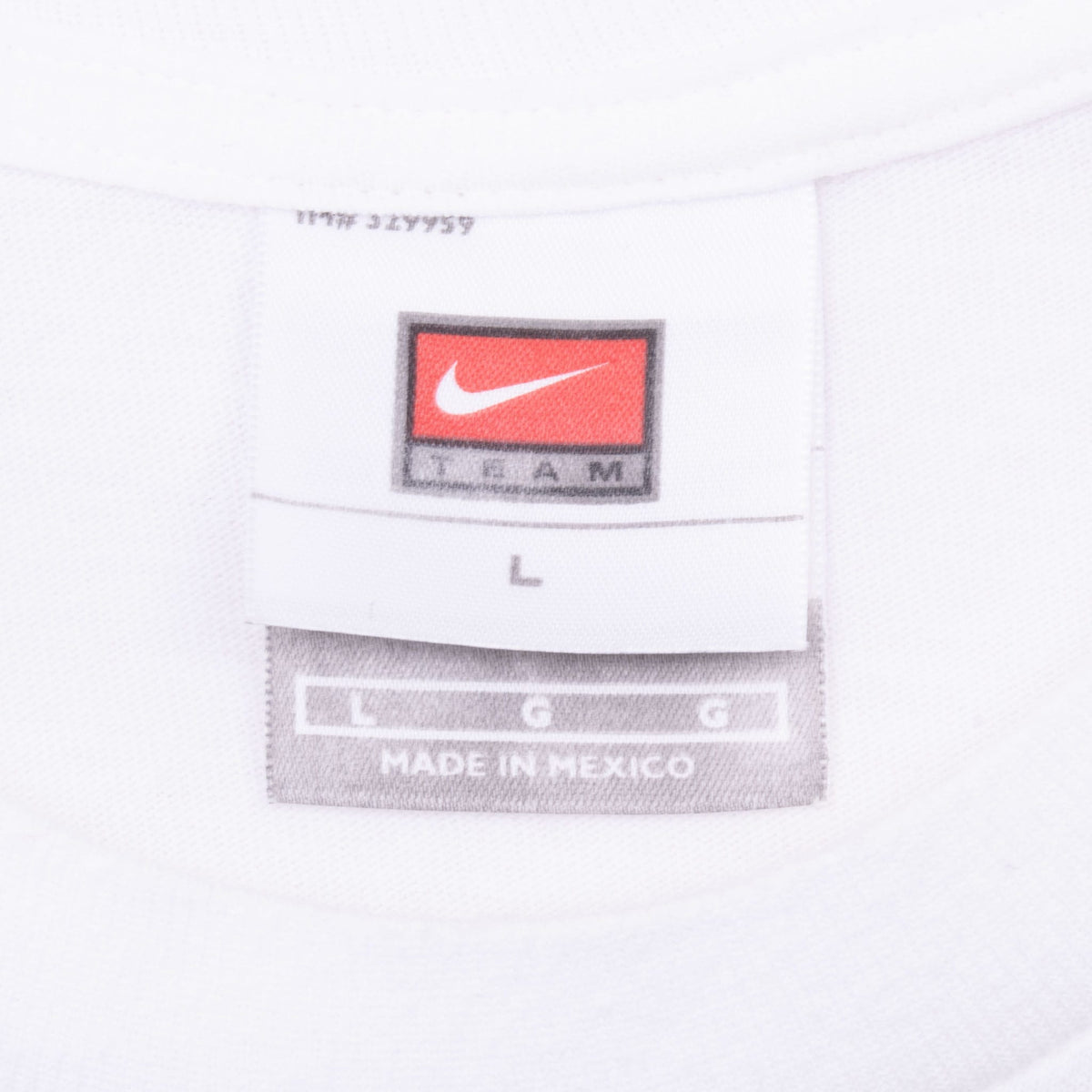 Nike neck tag on white Team USA soccer T-shirt marked size L and Made in Mexico