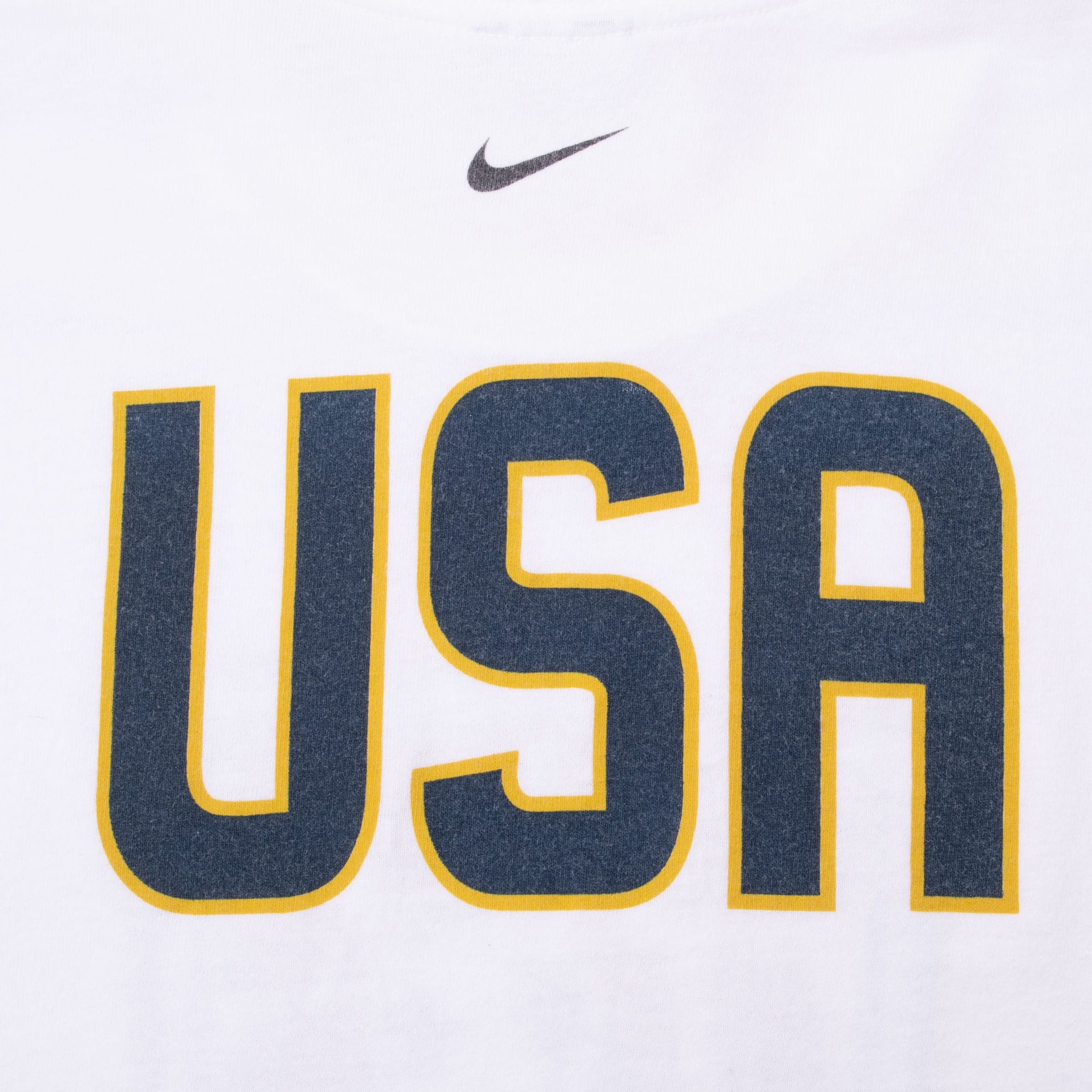 Close-up of back navy USA print with gold outline and Nike Swoosh at upper neck