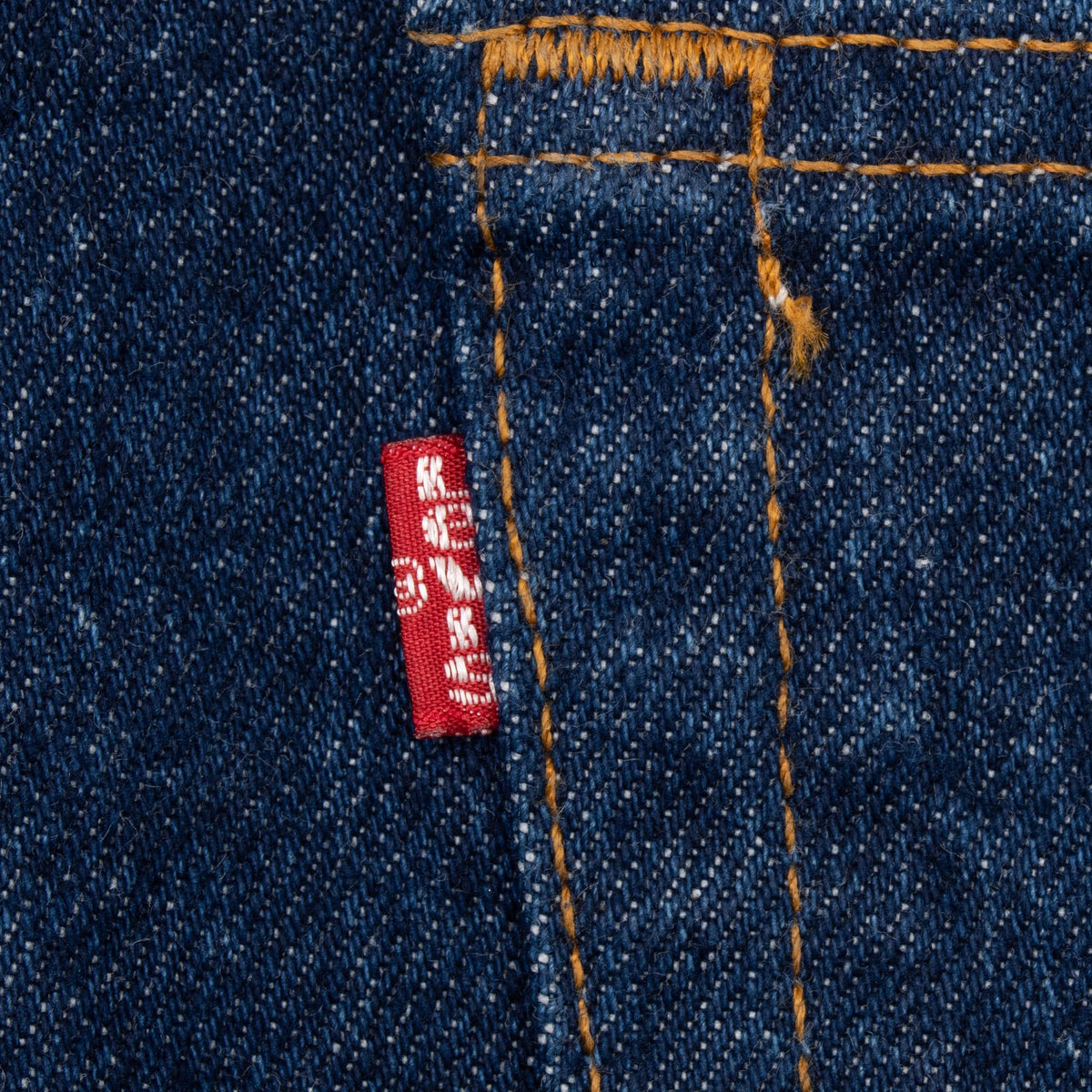 Close-up of the Levi's red tab and contrast stitching on dark indigo denim
