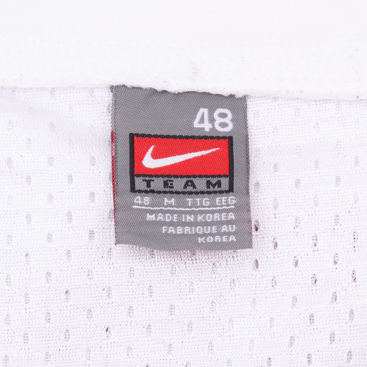 Nike Team size 48 neck label on white mesh jersey fabric