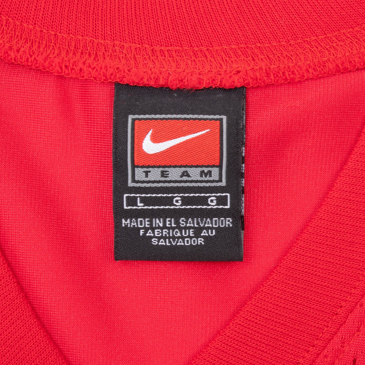 Close-up of Nike Team neck label inside the red jersey collar
