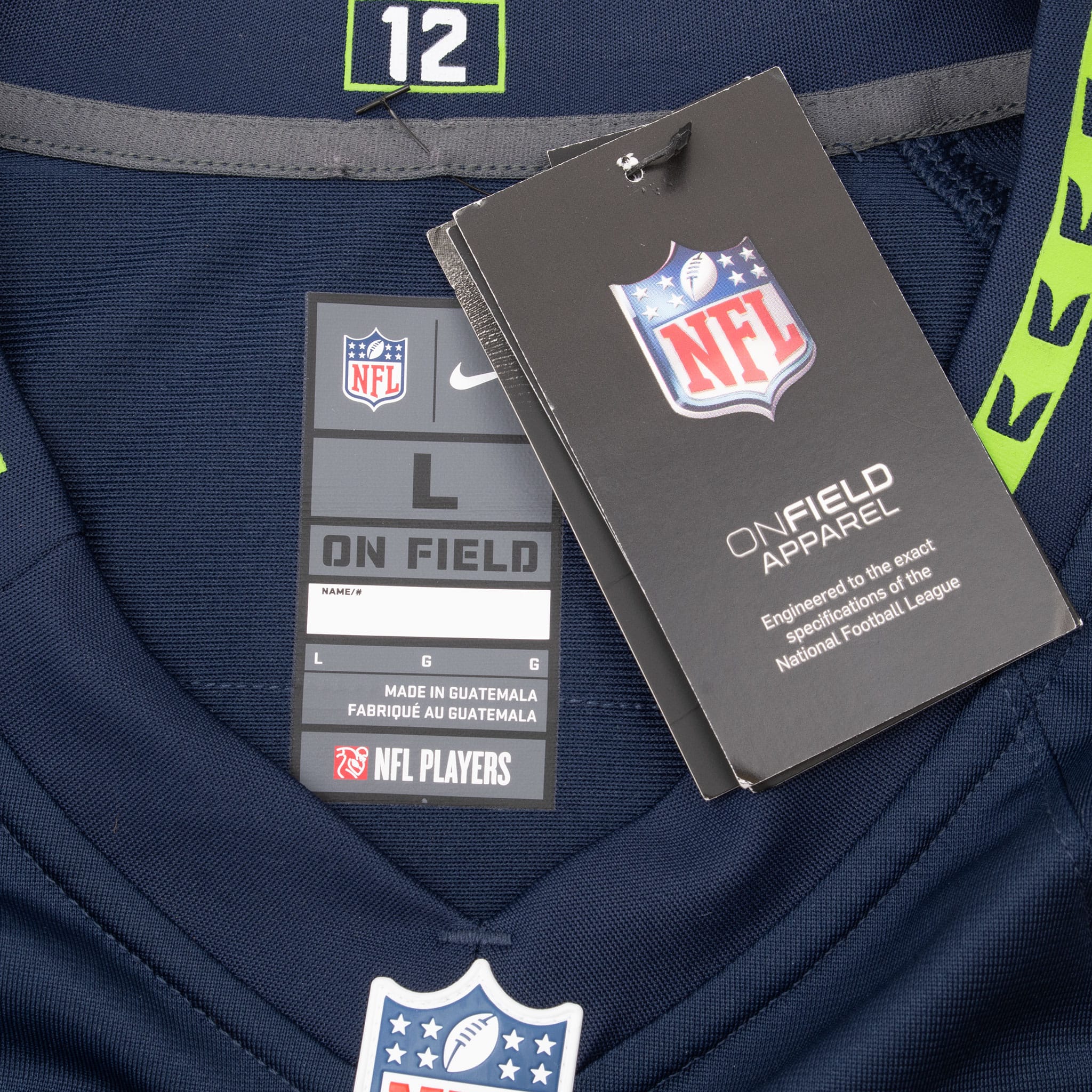 Nike NFL jersey neck label and attached NFL On Field Apparel retail tags, size large