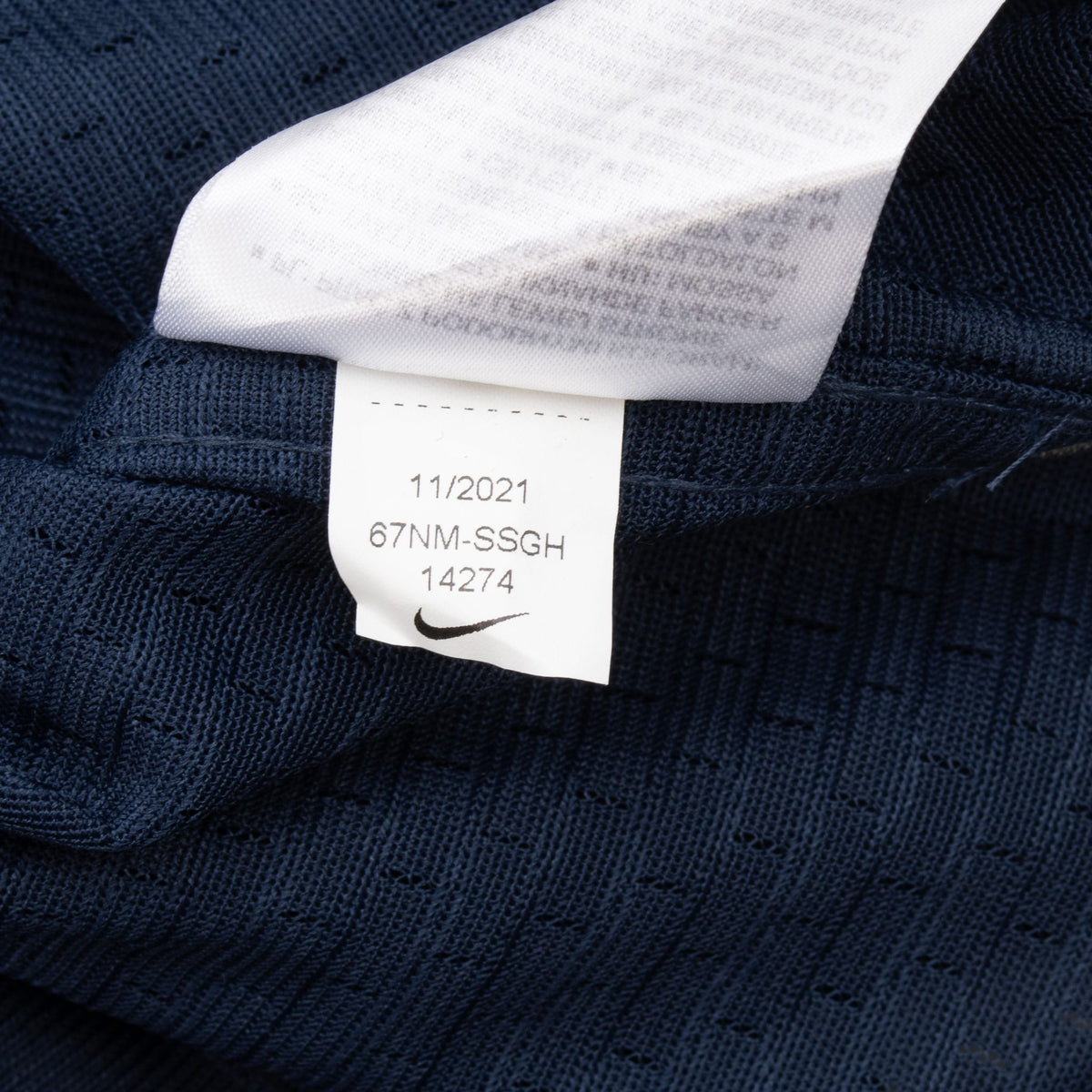 Close-up of interior Nike product label and navy jersey fabric