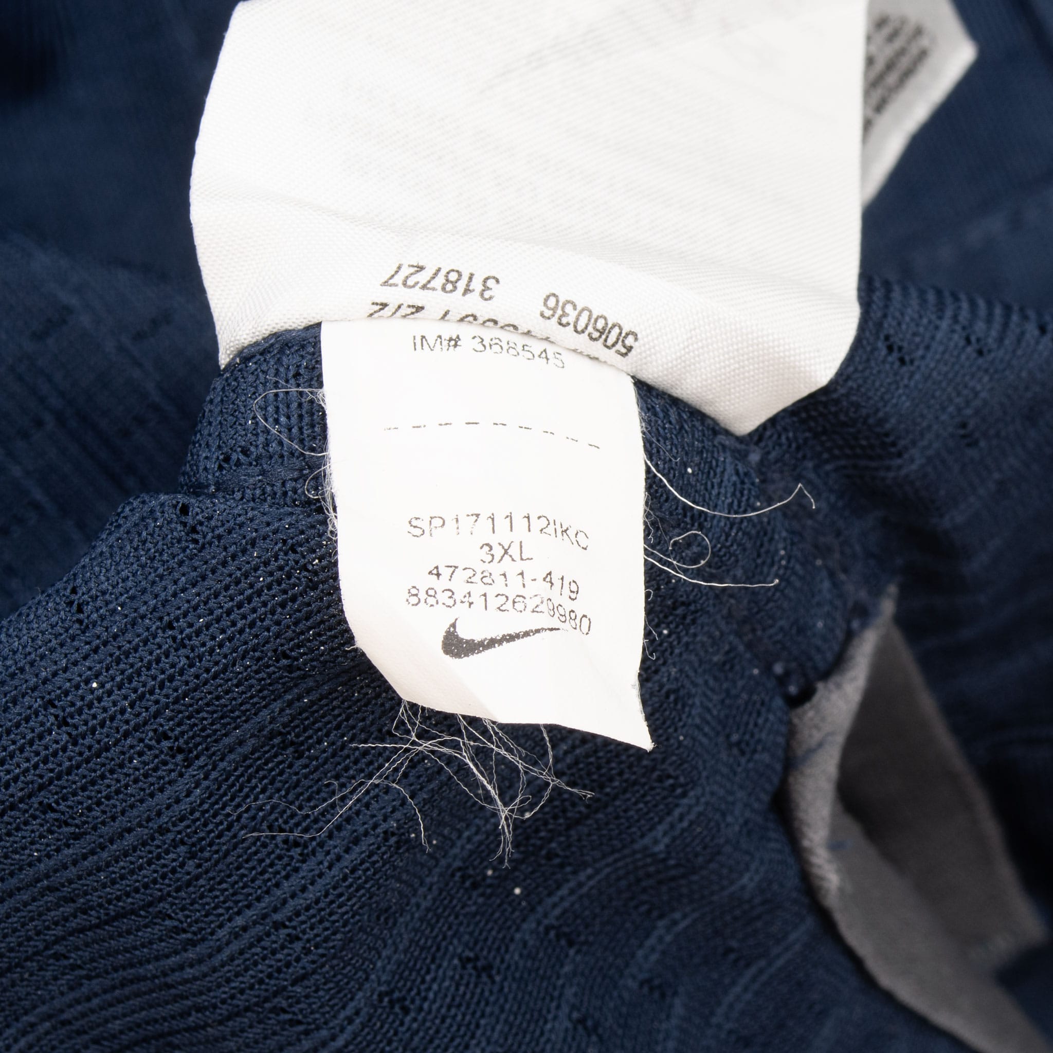Close-up of interior care and product tags on navy jersey fabric