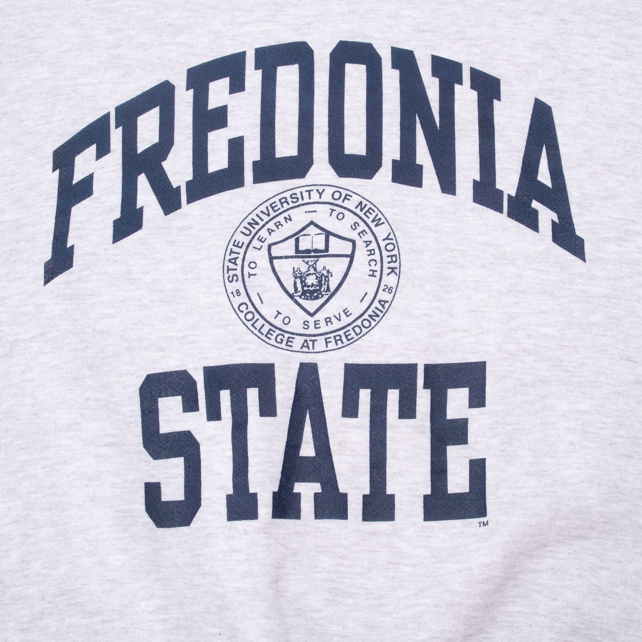 Close-up of navy Fredonia State lettering and university seal front graphic
