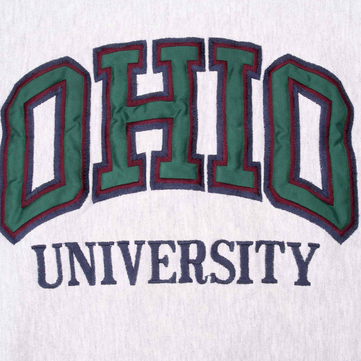 Close-up of green, burgundy and navy Ohio University chest embroidery