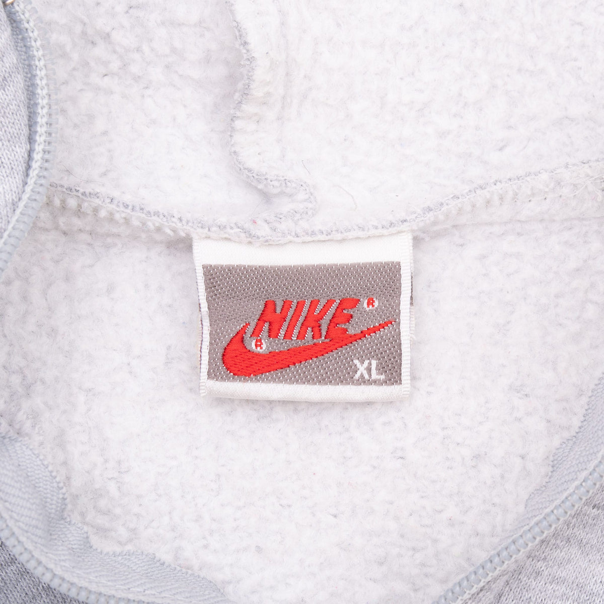 Nike neck tag marked XL inside grey hoodie