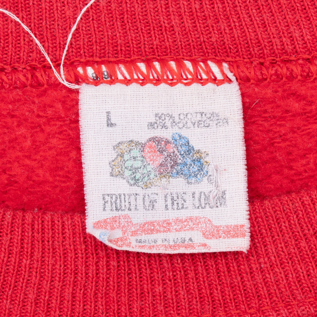 Close-up of sweatshirt neck tag marked L and Fruit of the Loom