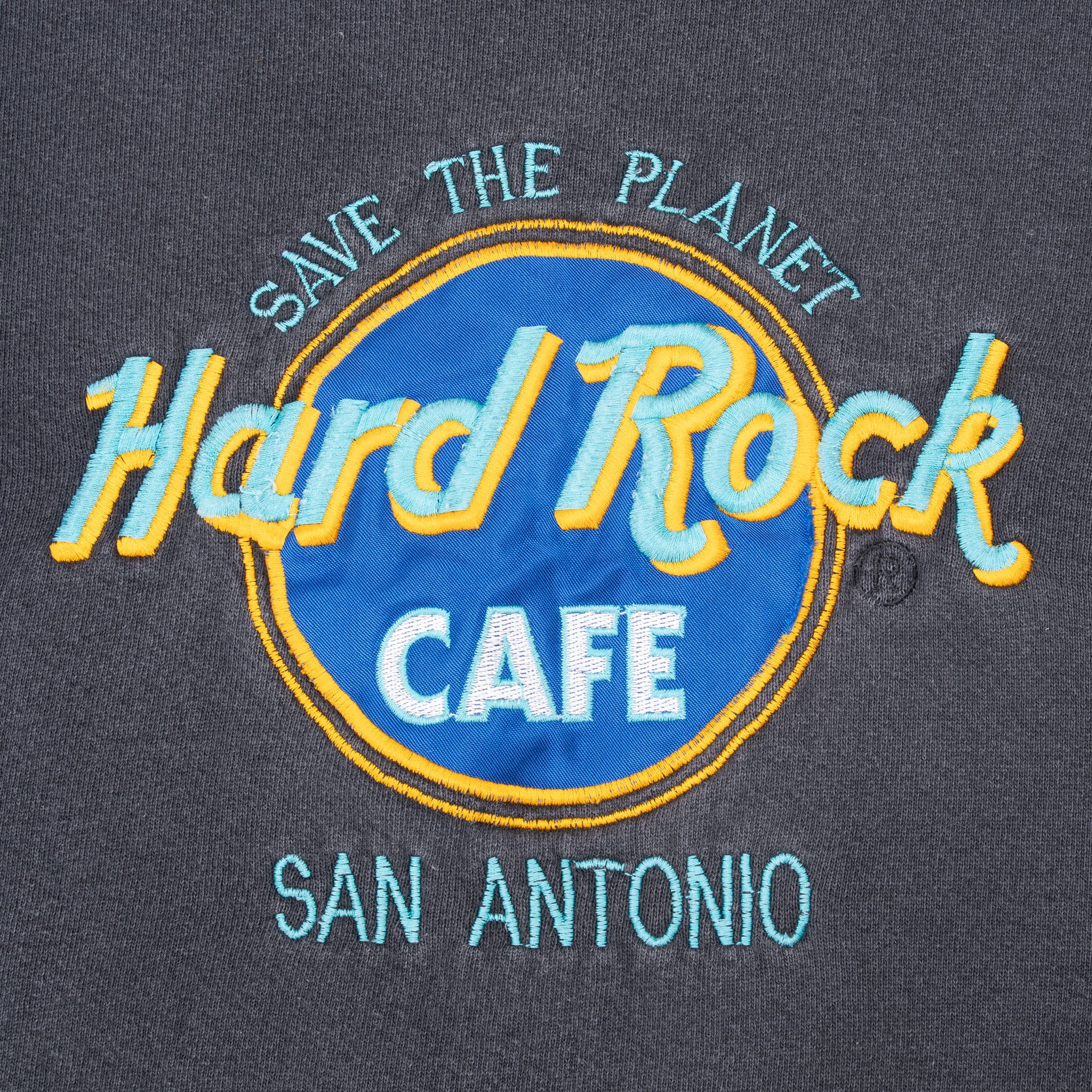 Close-up of blue, turquoise, orange and white Hard Rock Cafe San Antonio embroidered logo