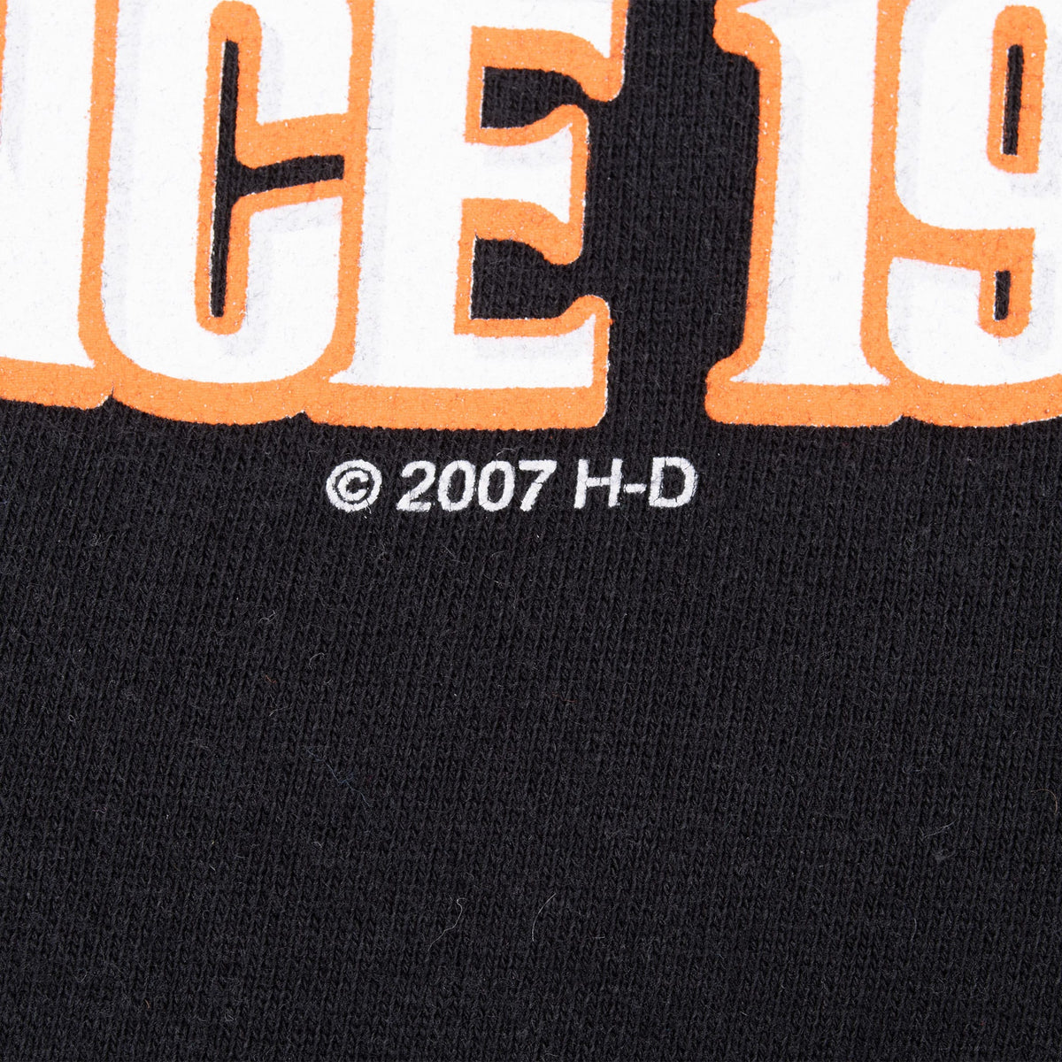 Close-up of © 2007 H-D text beneath the front print on black sweatshirt fabric