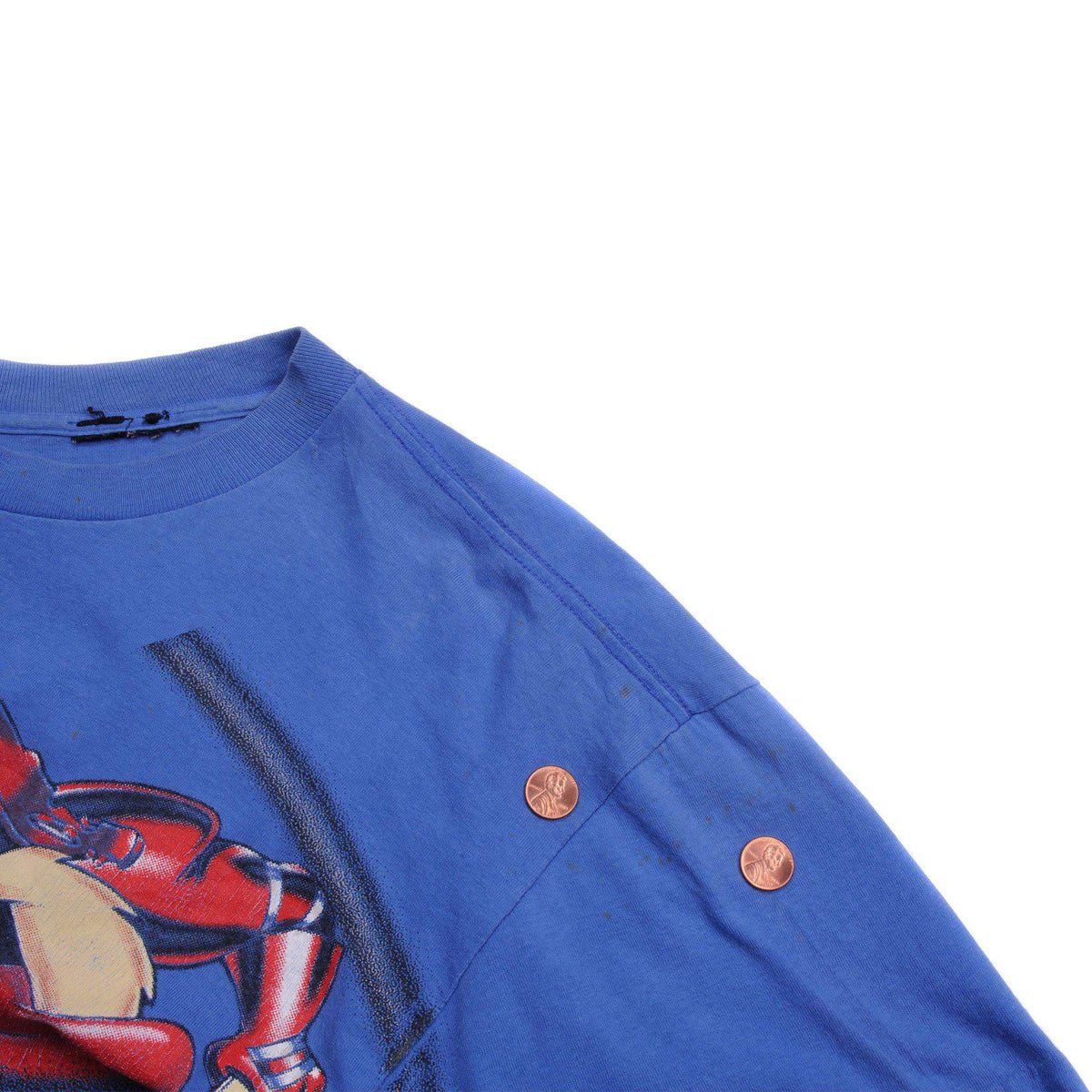 Blue shoulder and sleeve detail with two pennies placed beside small marks