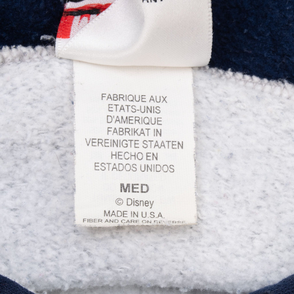 Disney hoodie care label showing medium size and Made in USA text