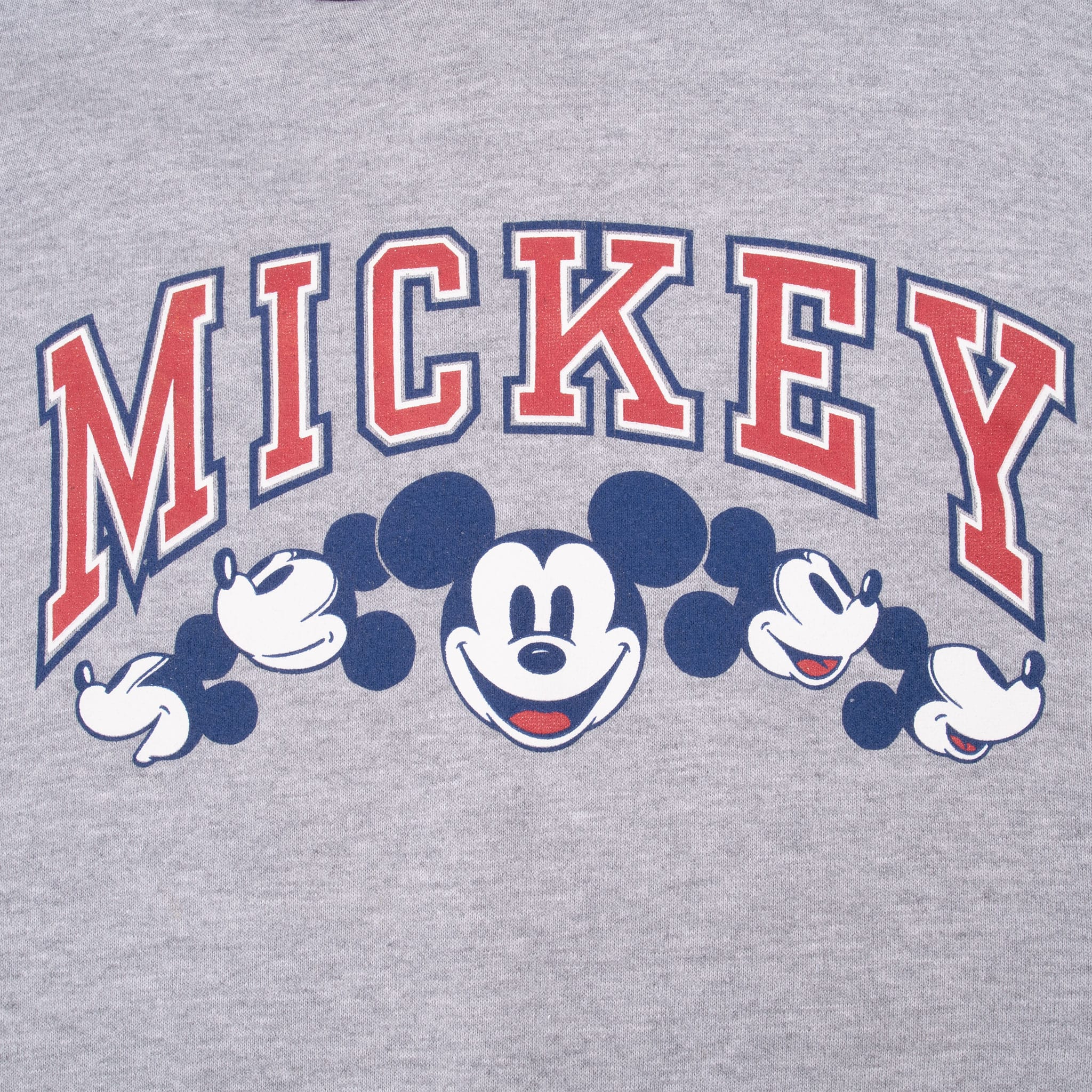 Close-up of red, white and navy collegiate Mickey graphic with five Mickey Mouse portraits