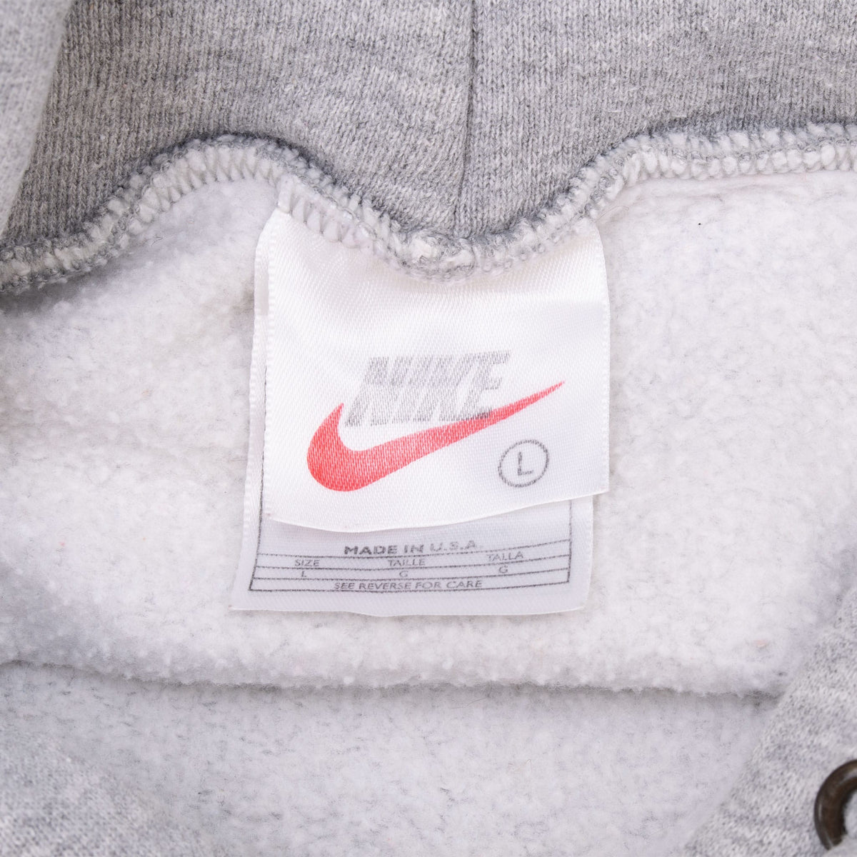 Nike neck tag marked size large and Made in USA inside grey hoodie