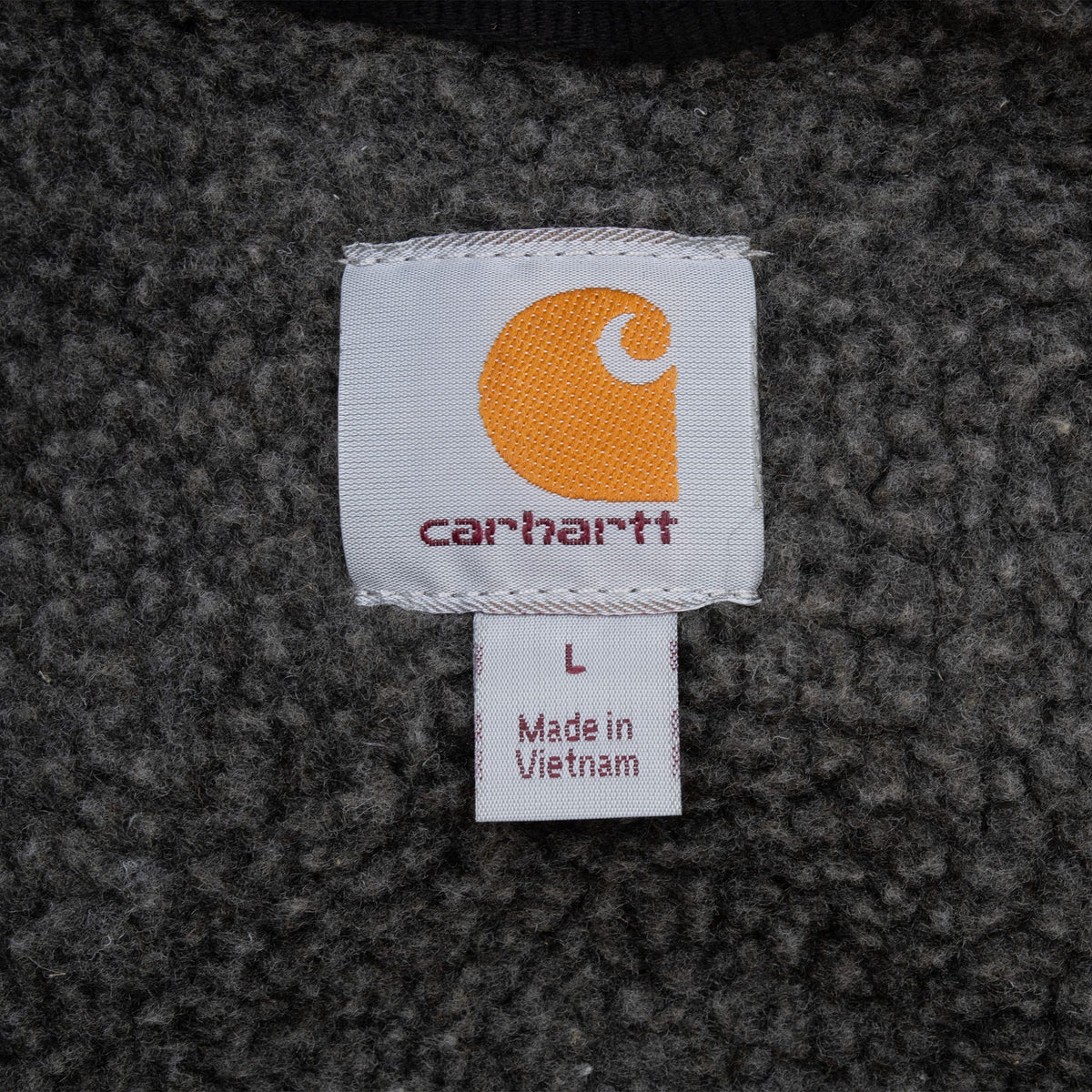 Carhartt neck label marked size L against gray sherpa lining