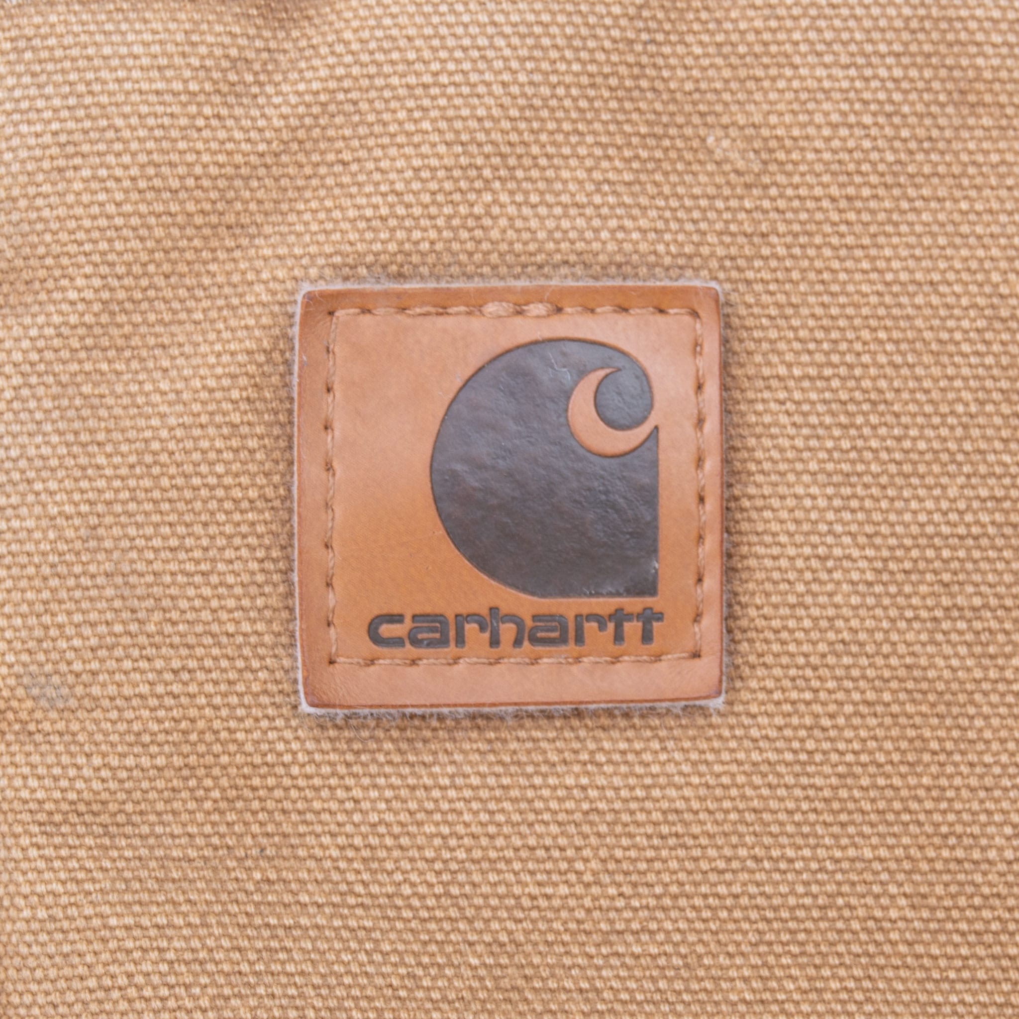 Close-up of Carhartt logo patch on brown front pocket