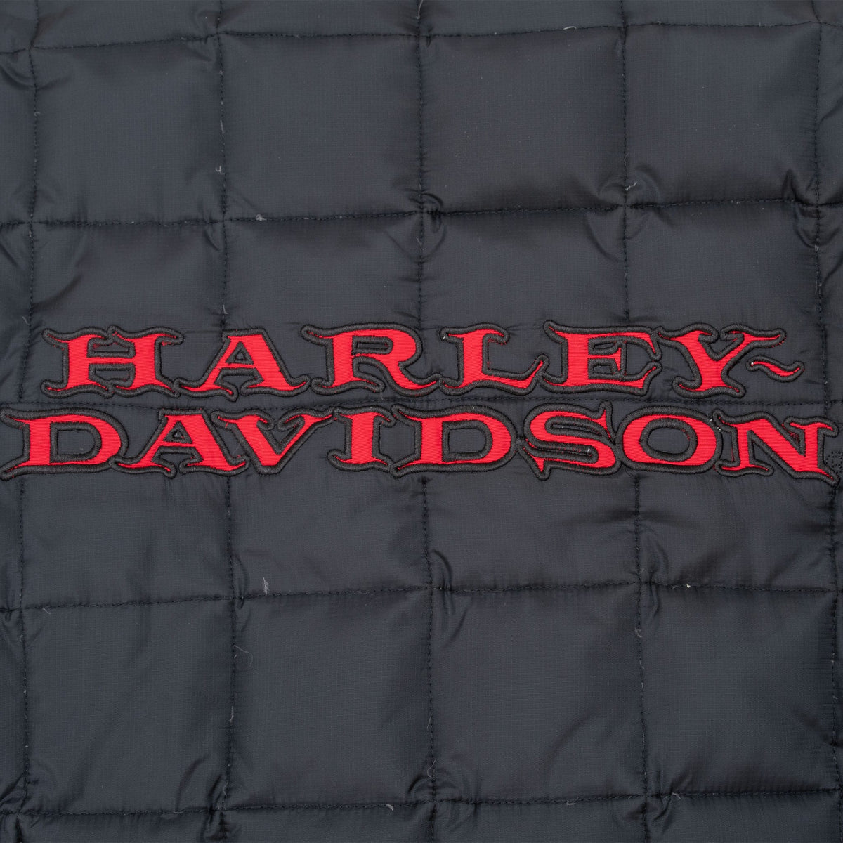 Close-up of red Harley-Davidson embroidery across the quilted jacket back