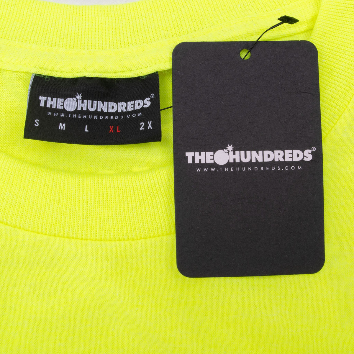 The Hundreds XL neck label and black hangtag on neon yellow T-shirt