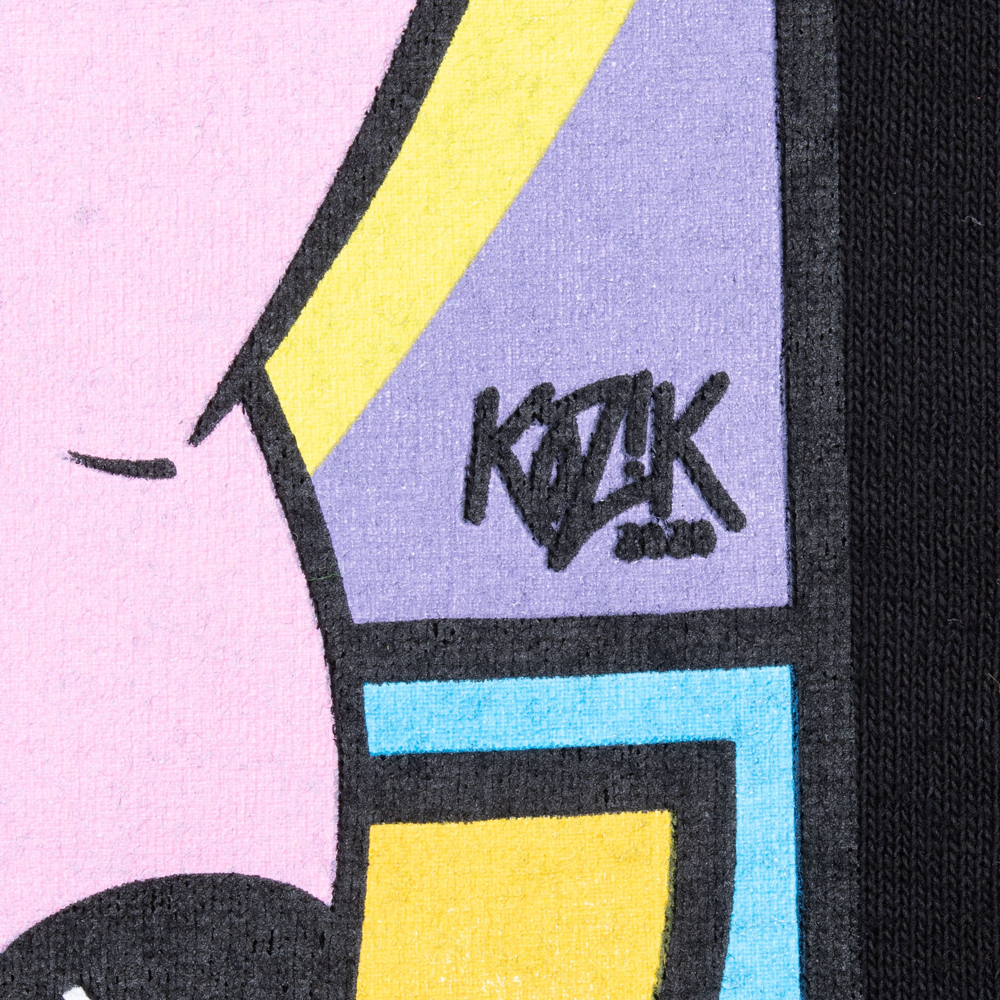Close-up of Kozik signature within the colorful front graphic