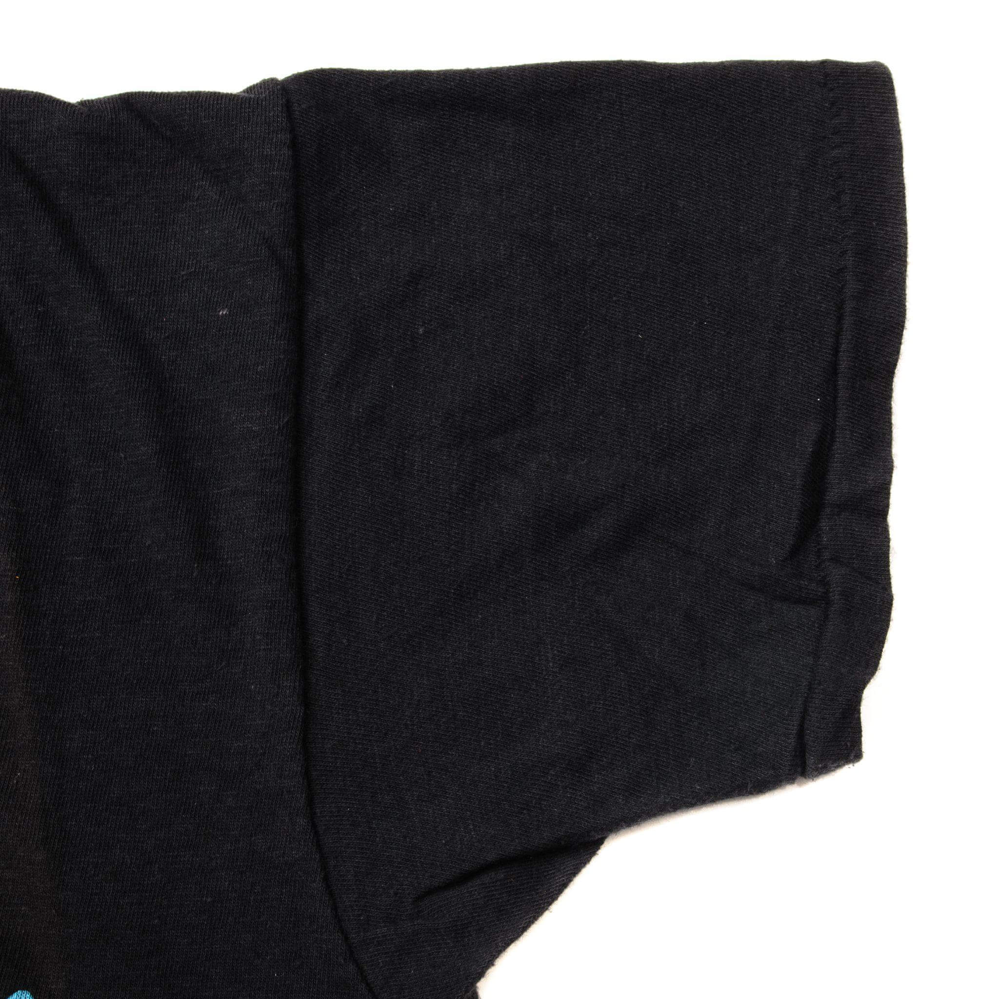 Close-up of the black T-shirt sleeve and single-stitch hem