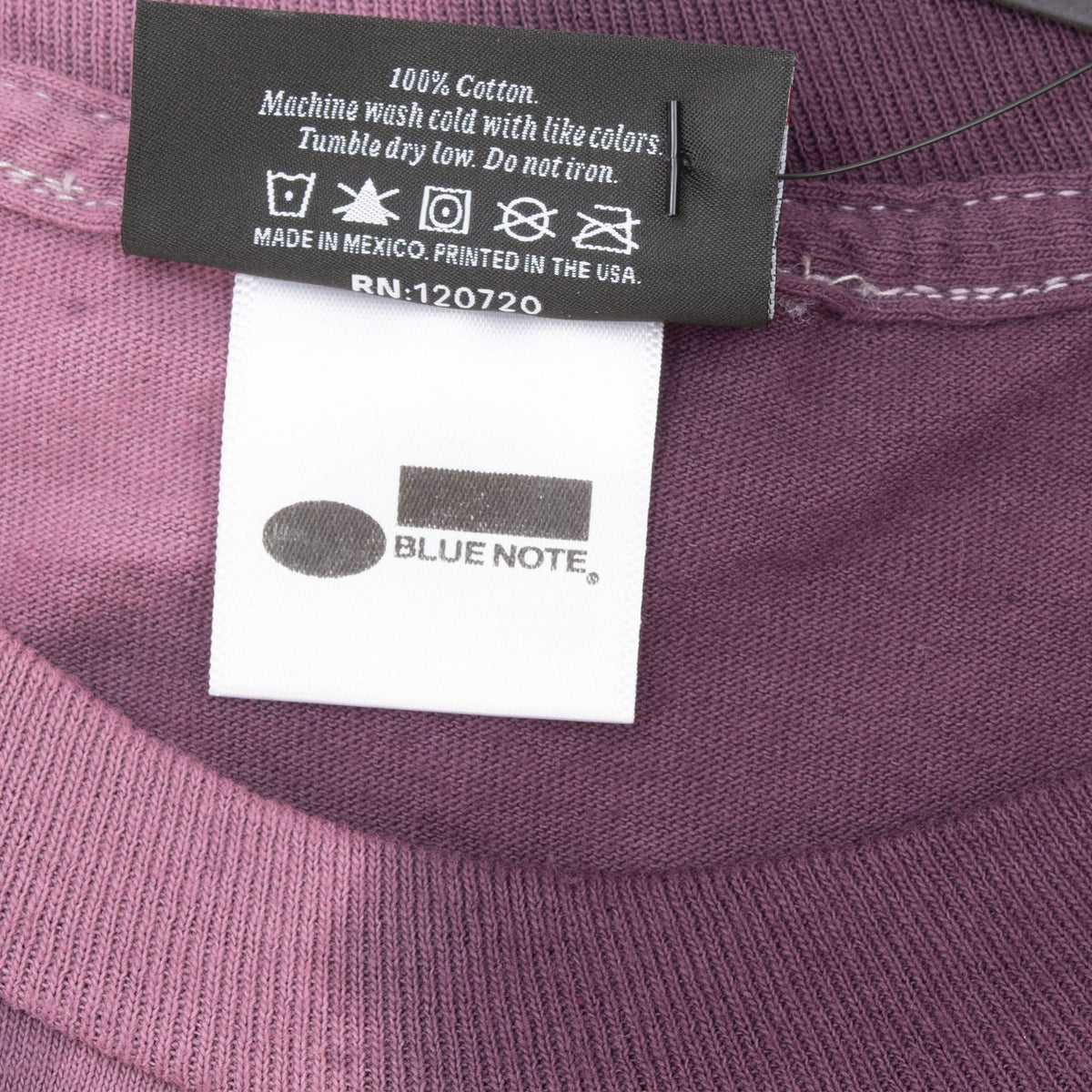 Close-up of care label and Blue Note neck label inside the purple shirt