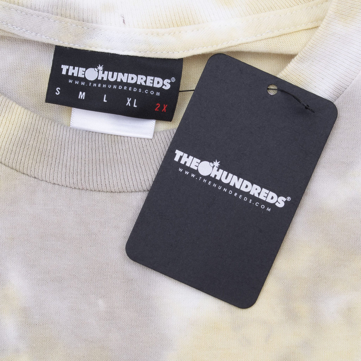 The Hundreds 2X neck label and black branded hangtag on tie-dye T-shirt