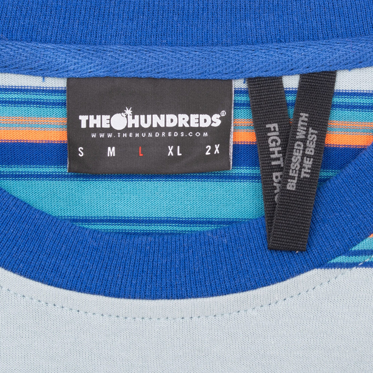 The Hundreds neck label with size large marked beside the royal blue ribbed crew neck