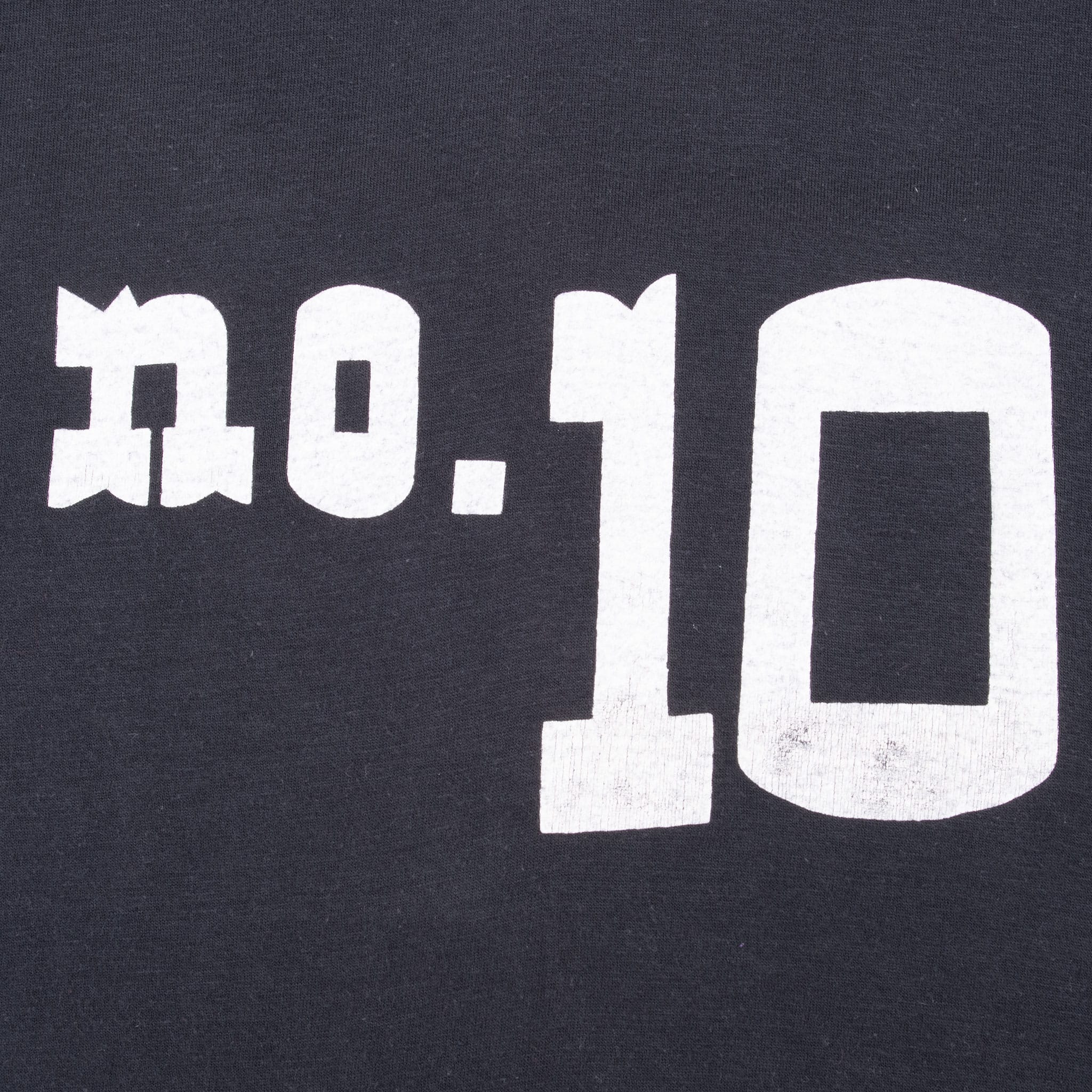 Close-up of white No. 10 front print on black fabric