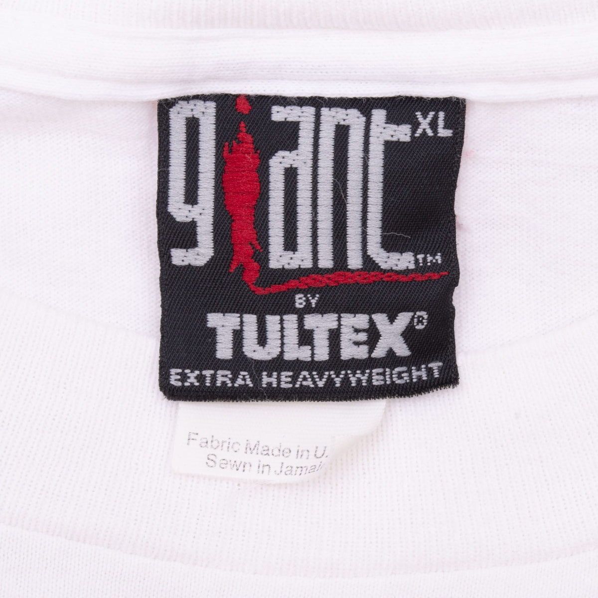 Close-up of 9TNT by Tultex XL neck tag on white MTV T-shirt