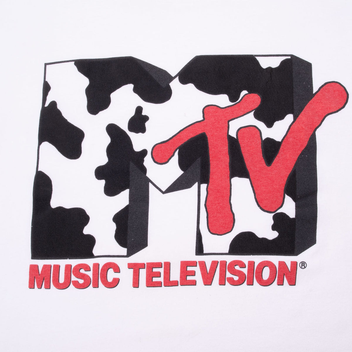 Close-up of MTV graphic with black-and-white cow print and red Music Television text