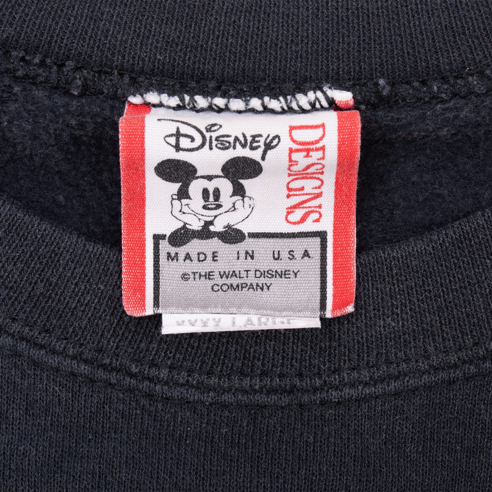 Disney Designs neck tag with Mickey Mouse graphic and Made in USA text