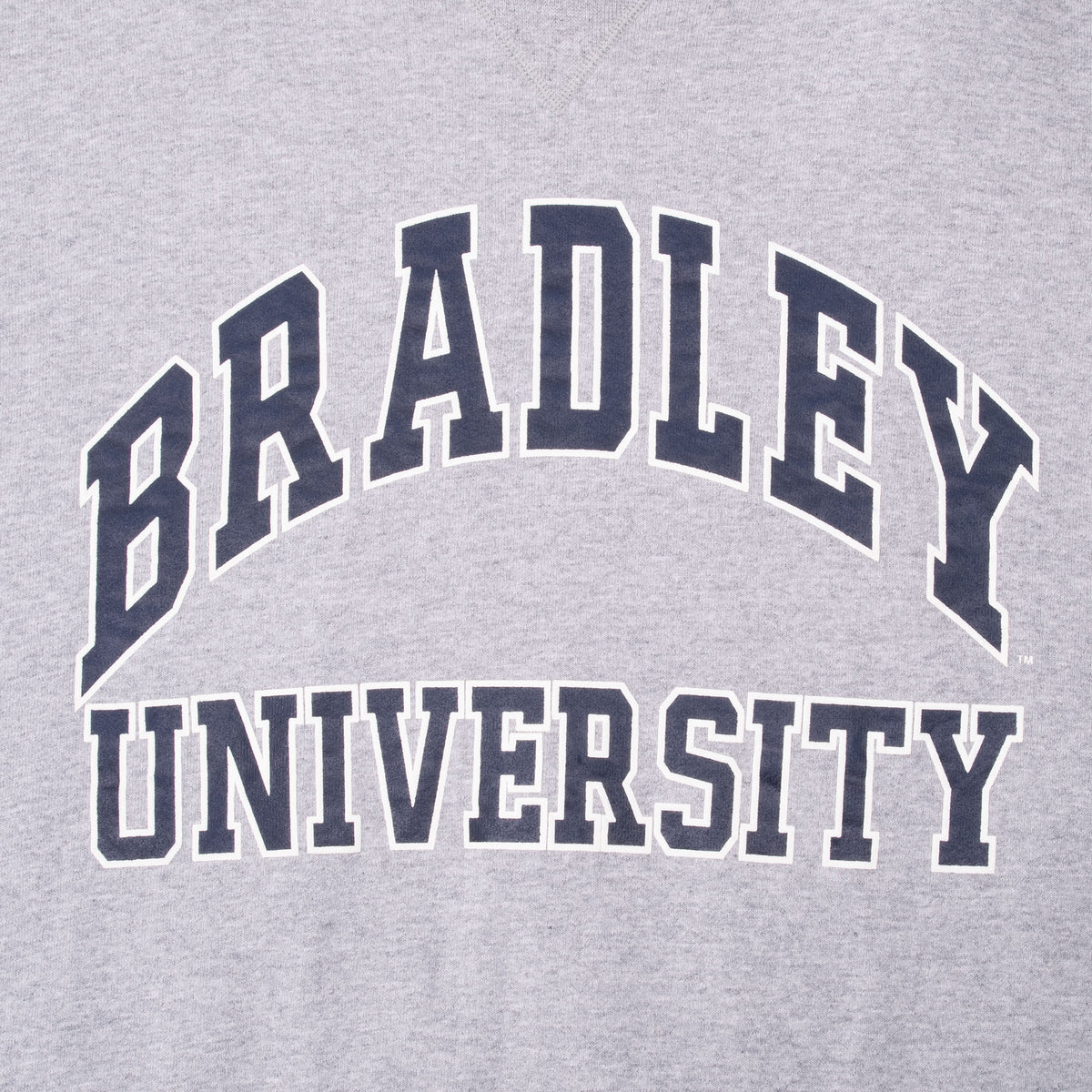 Close-up of navy and white Bradley University chest print on gray fabric