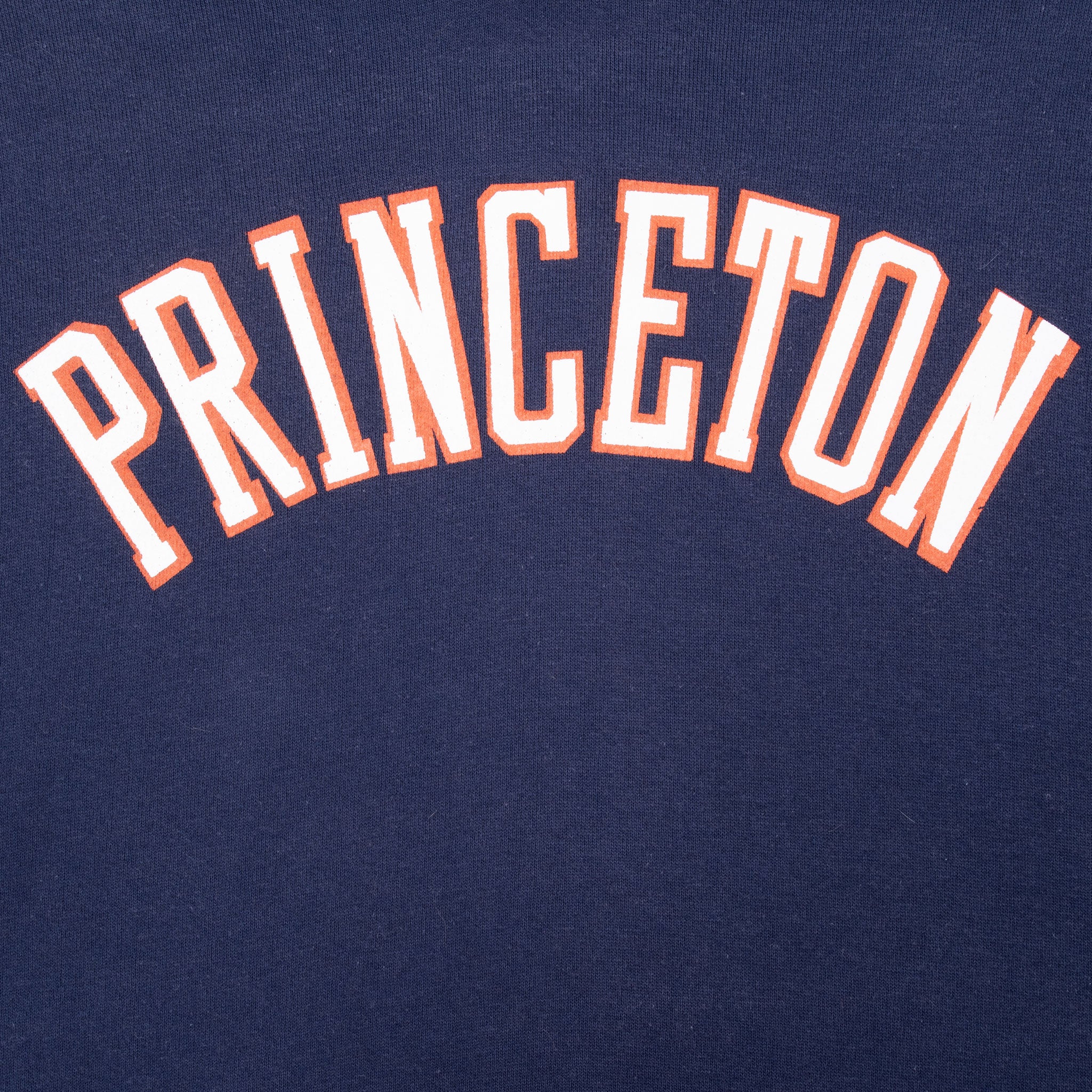 Close-up of arched white and orange Princeton chest lettering