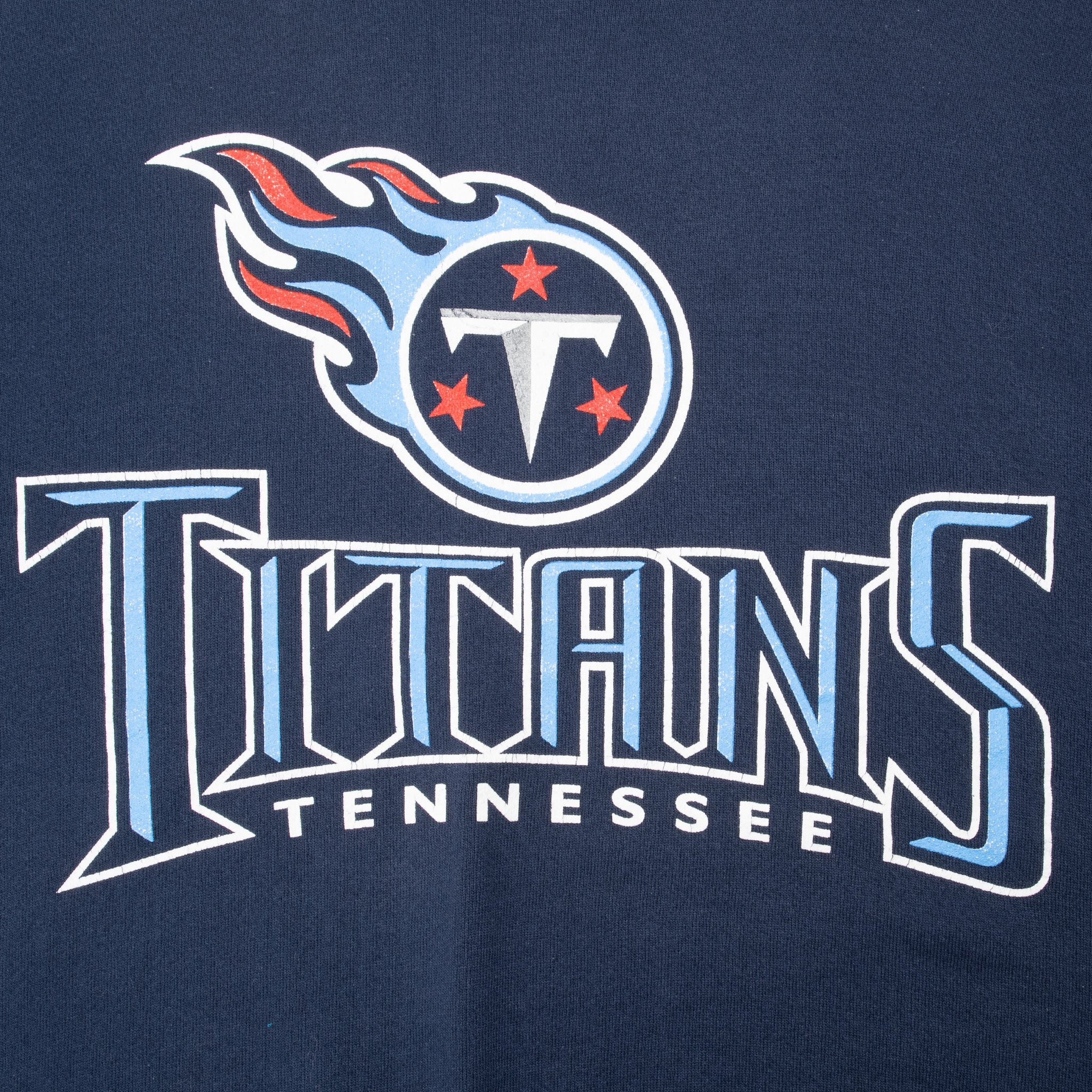 Close-up of Tennessee Titans logo and team name graphic on navy sweatshirt