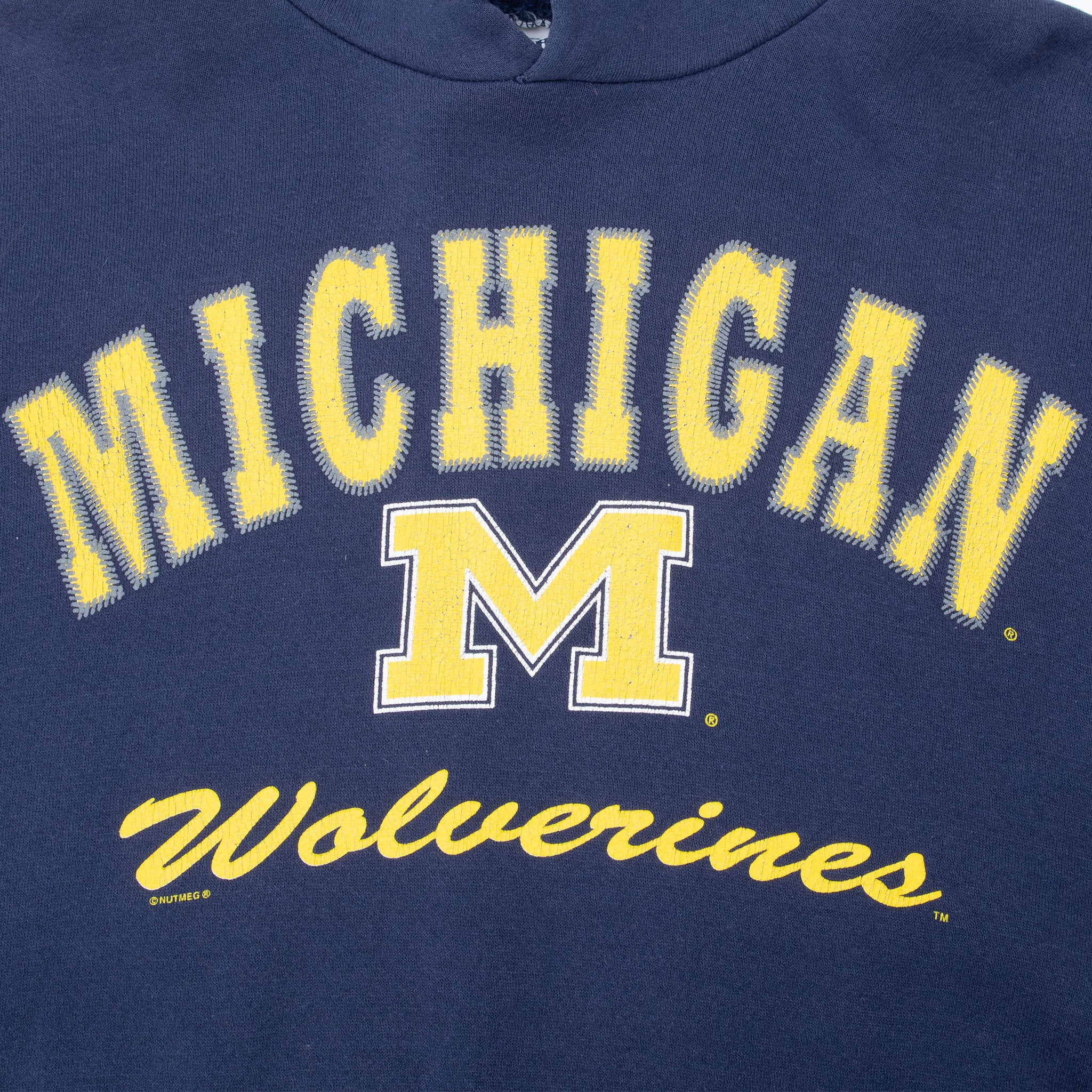Close-up of maize Michigan Wolverines lettering and block M chest graphic
