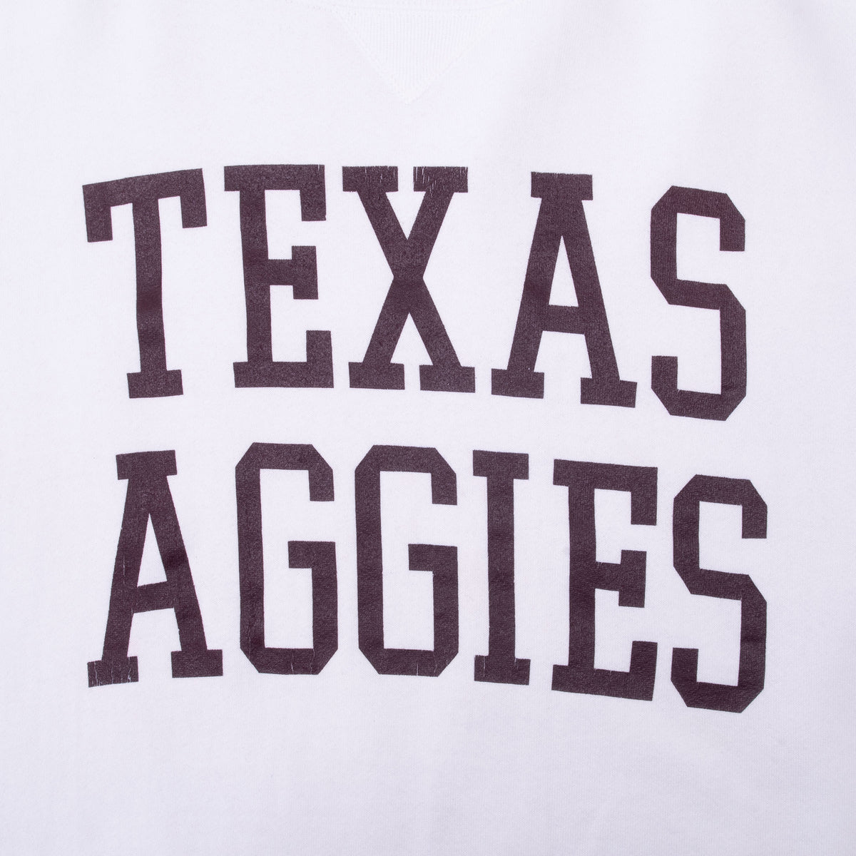 Close-up of maroon Texas Aggies chest print on white sweatshirt