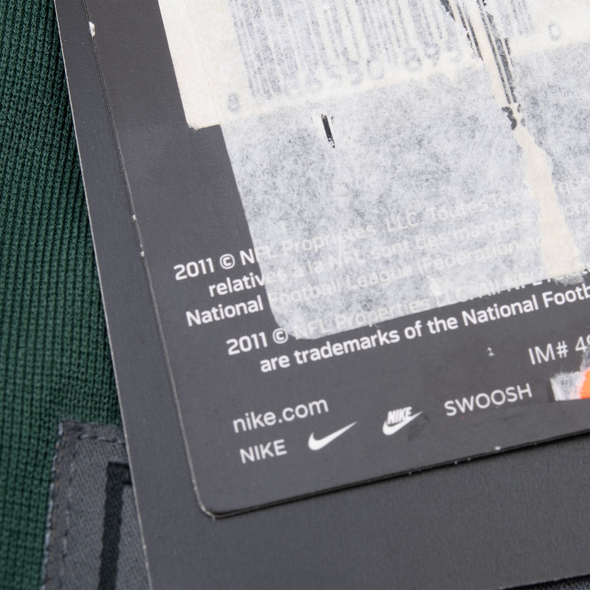 Reverse of attached product tag with NFL licensing text and Nike Swoosh
