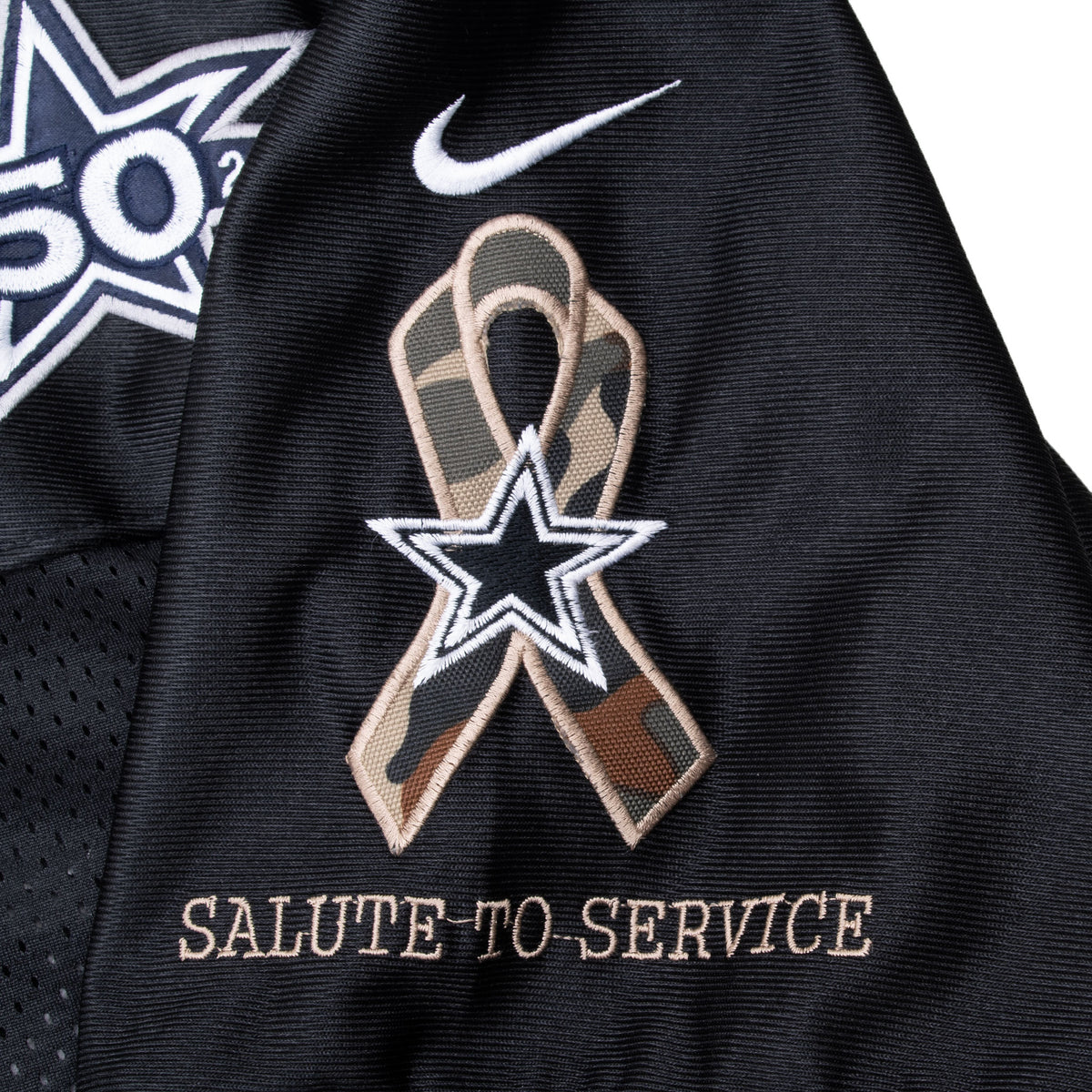 Close-up of camouflage ribbon, Cowboys star and Salute to Service sleeve embroidery