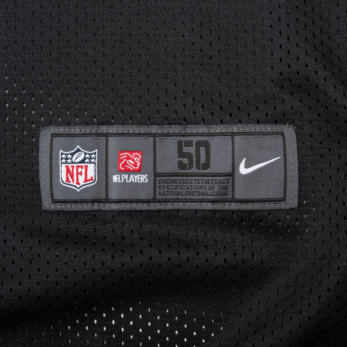 Close-up of Nike NFL Players size 50 jock tag on black mesh jersey