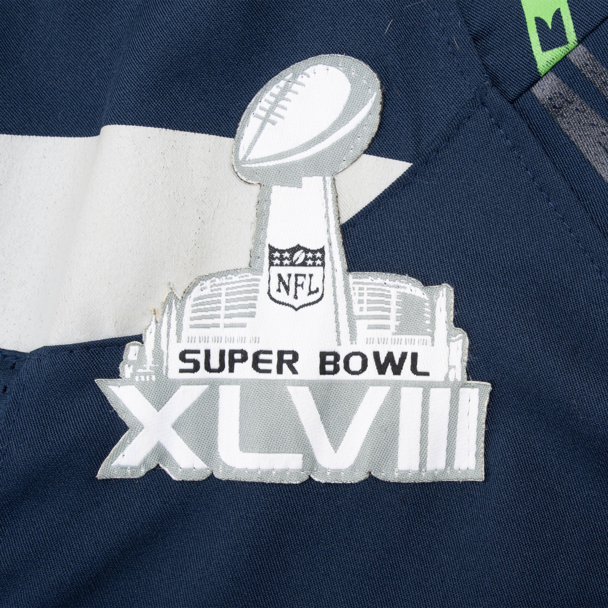 Close-up of Super Bowl XLVIII chest patch on navy Seahawks jersey