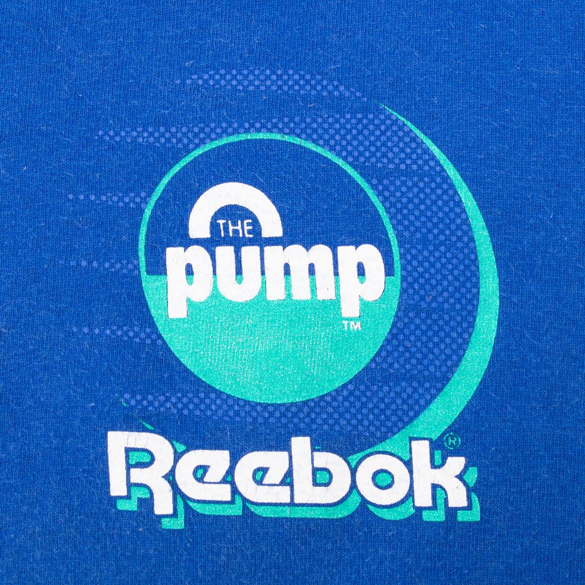 Close-up of white and green Reebok The Pump chest print