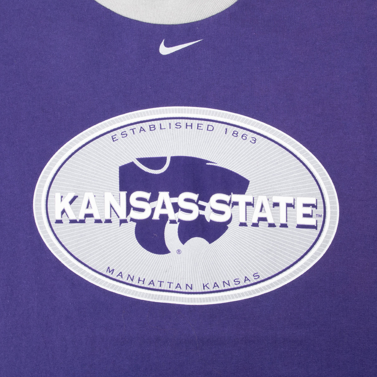Kansas State Wildcats oval chest graphic and white Nike Swoosh on purple T-shirt